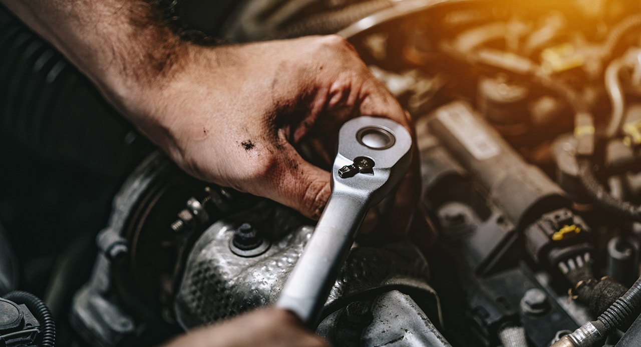 Hyundai maintenance technician working under the hood