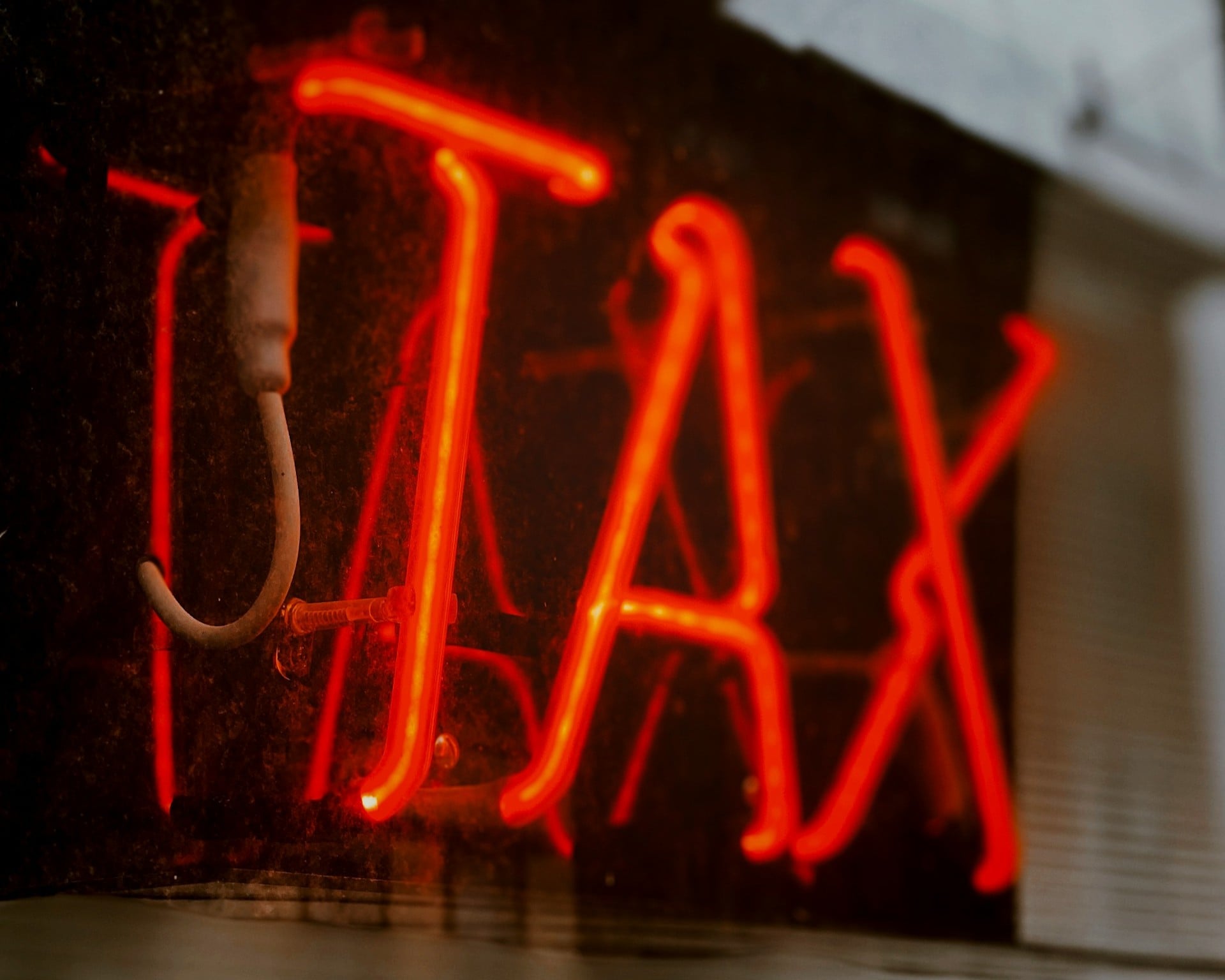 neon sign that says TAX