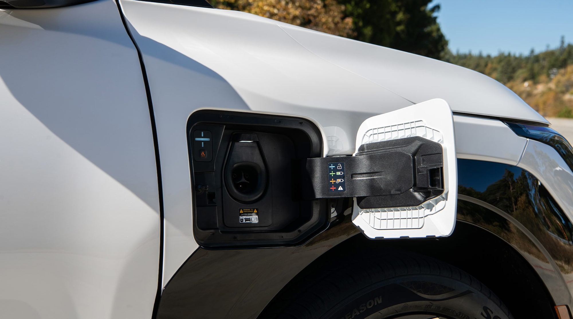 North American Charging System (NACS) port shown on the GT-Line in Snow White Pearl.