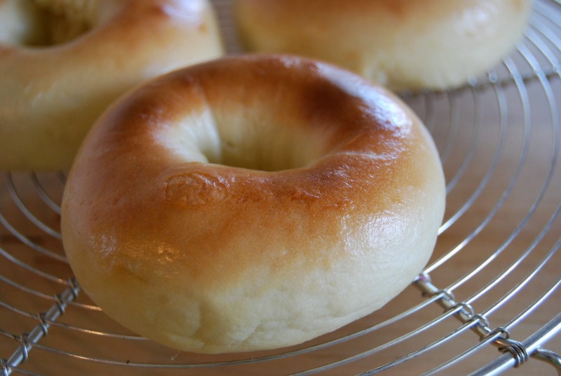 freshly cooked and unsliced bagel cooling on a wire rack