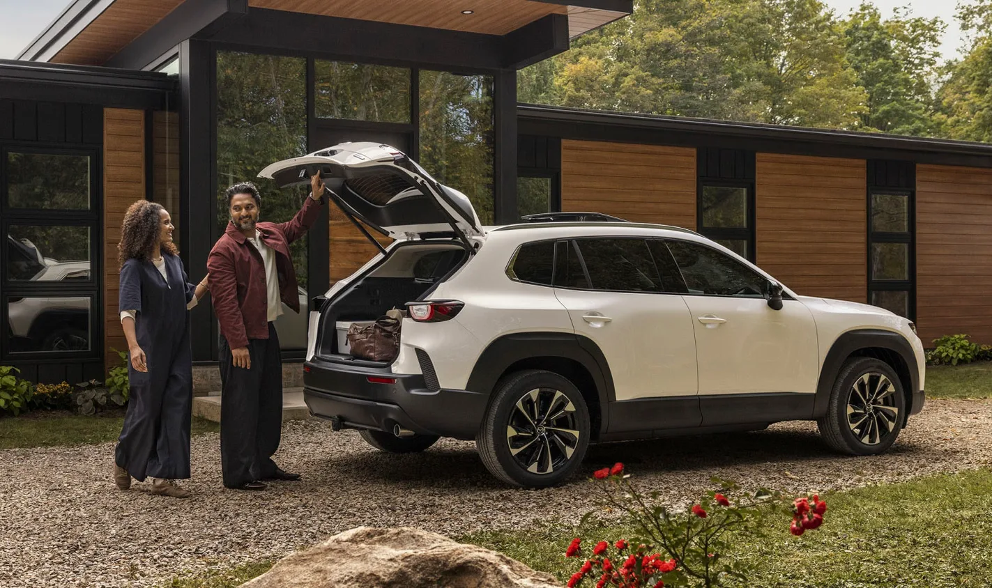 A couple loading their 2026 Mazda CX-50 Hybrid with items