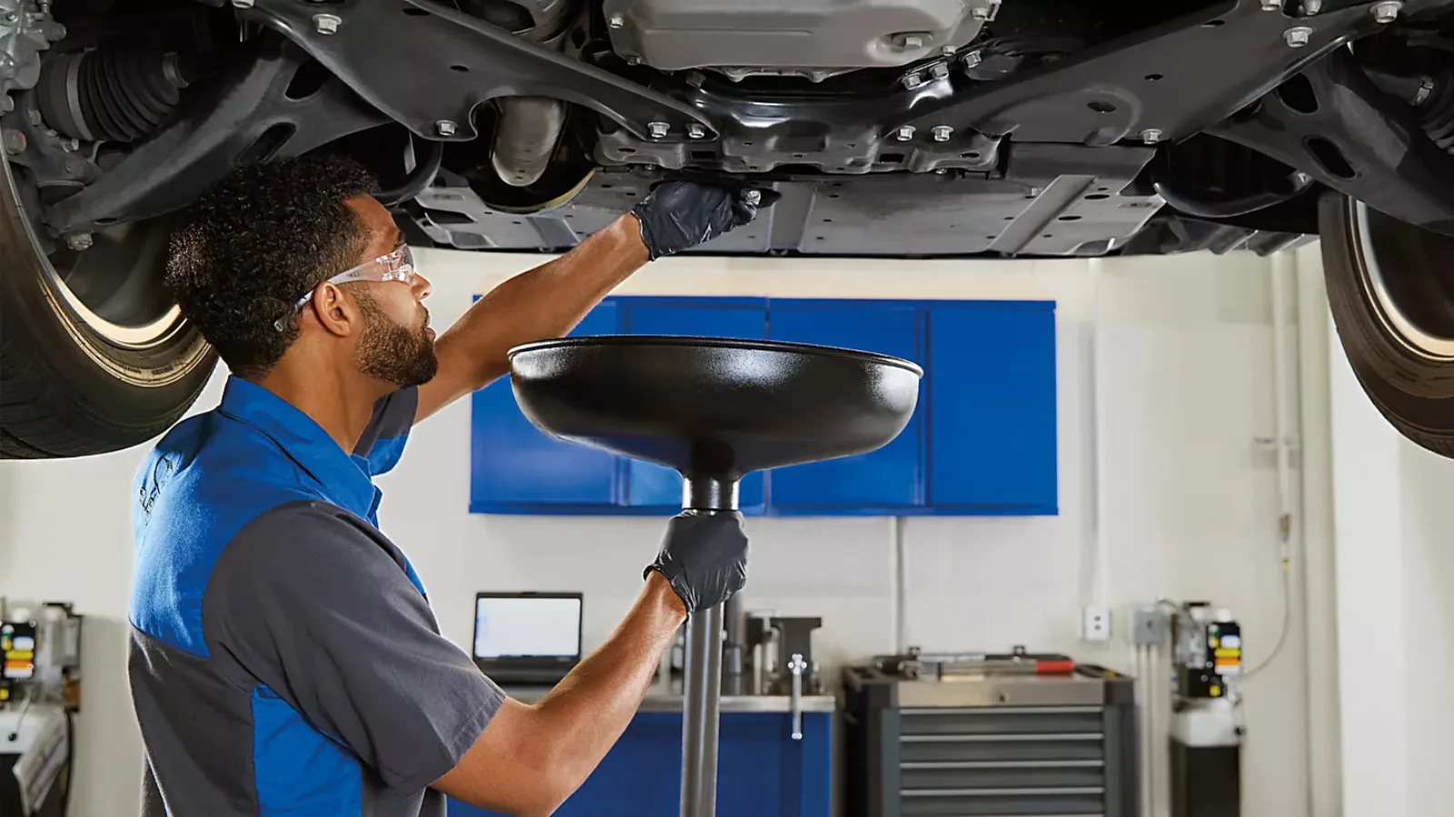 Technician performing an oil change at Koeppel Subaru