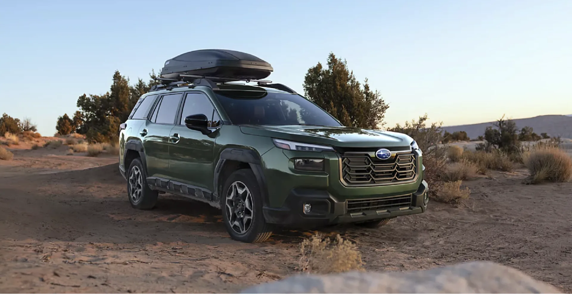 The 2026 Subaru Outback Touring shown in Deep Emerald Green Pearl with accessory equipment