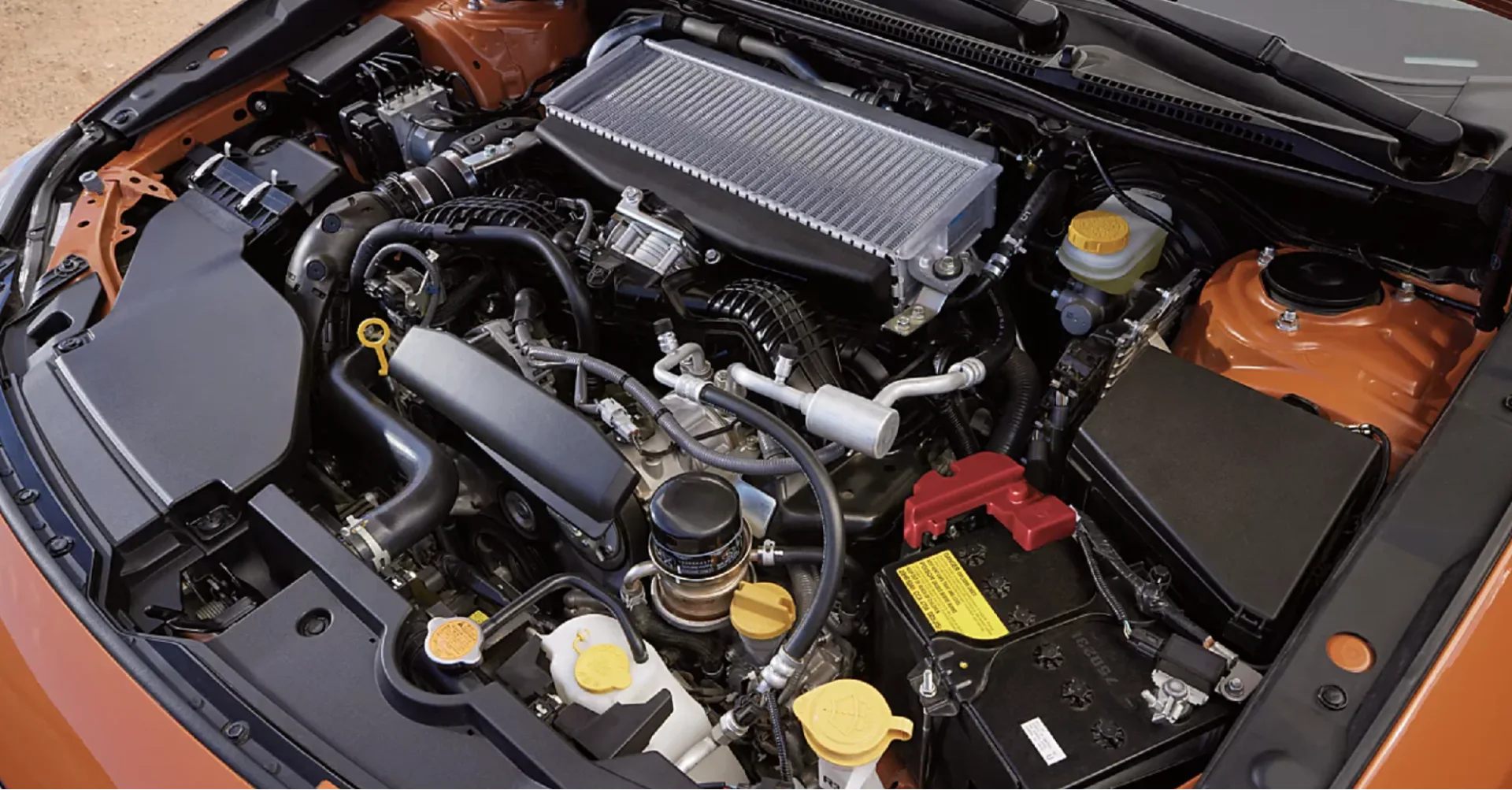 Subaru BOXER engine under the hood of a Subaru vehicle, showing its flat, horizontally opposed layout
