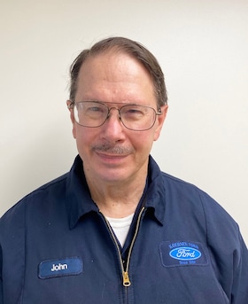 Staff member John Moras from 8586a6ab09ce