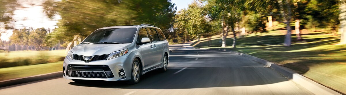 New Toyota Sienna driving through the woods