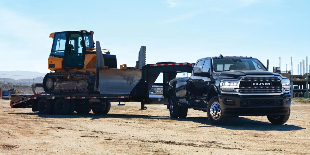 RAM 3500 towing a bulldozer