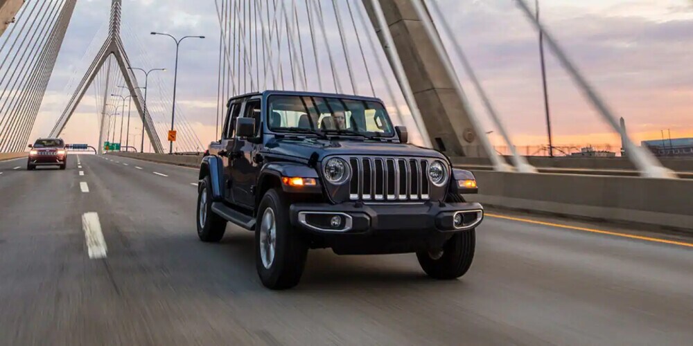 2023 Jeep Wrangler driving on a bridge