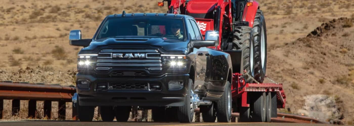 2026 RAM 3500 towing a farm tractor