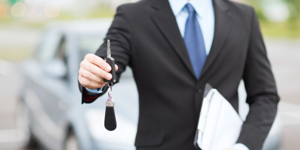 Salesperson handing over car keys
