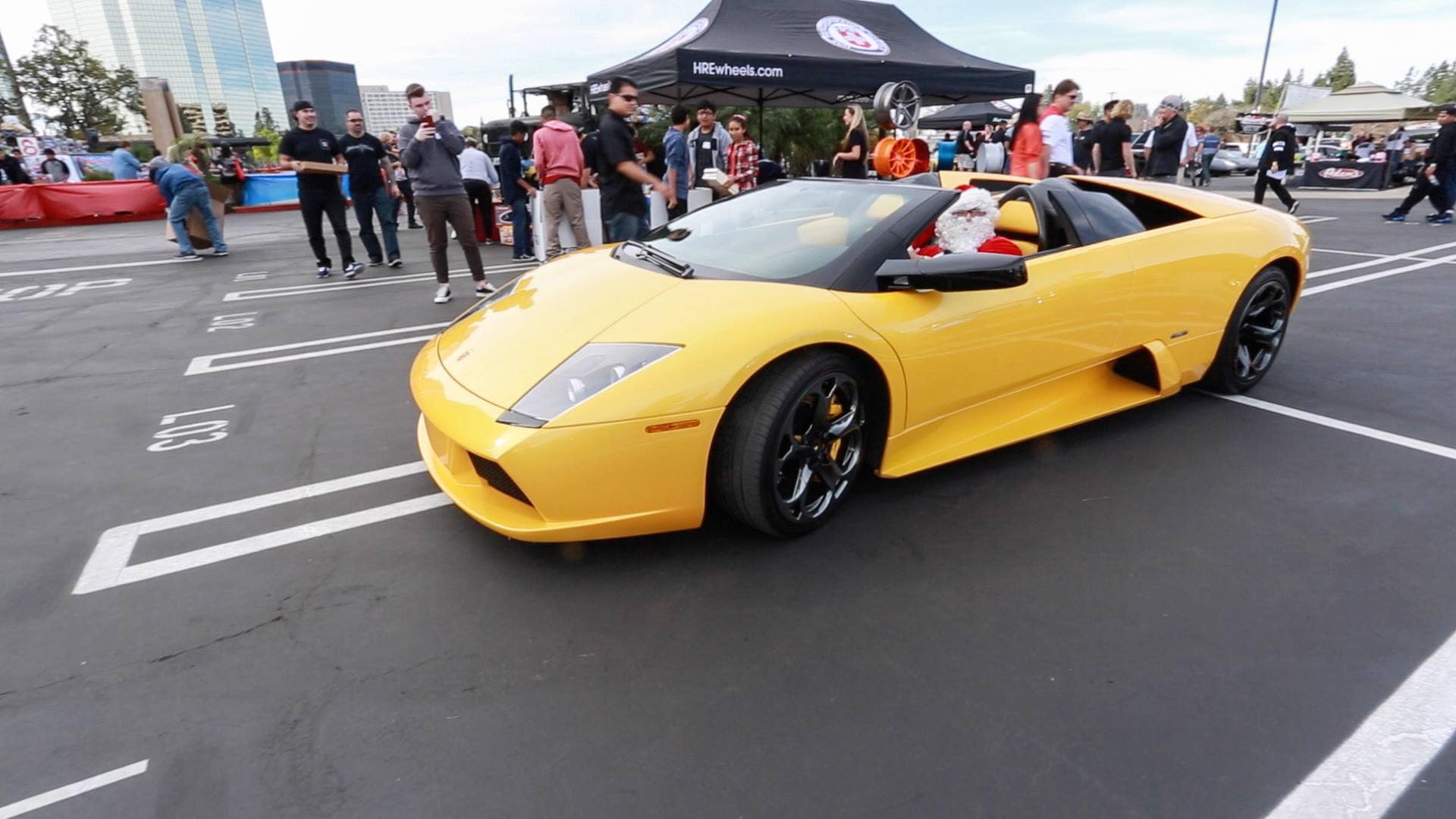 Santa Clause driving a Lamborghini to deliver toys for the kids at Motor 4 toys charity event