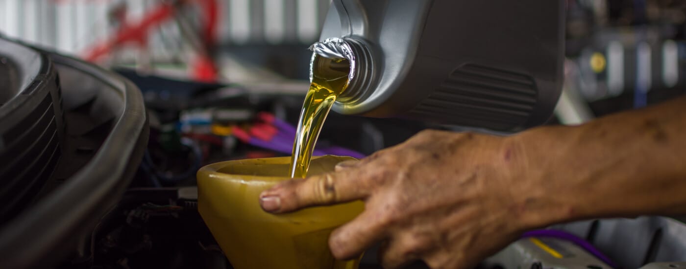 Oil being poured into car