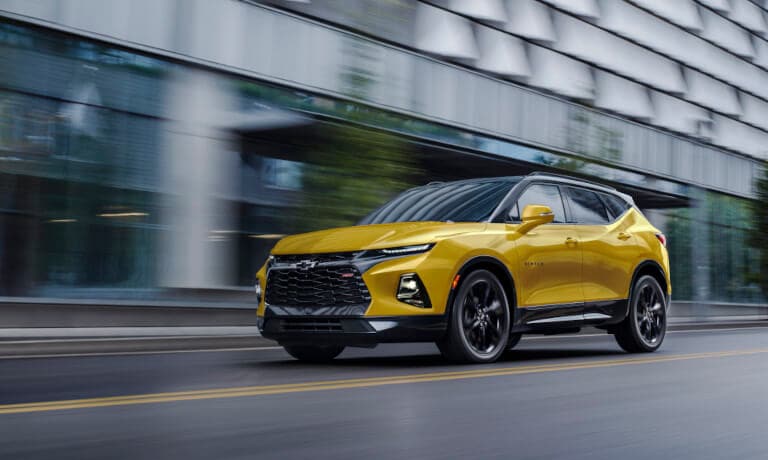 2023 Chevy Blazer in yellow color driving down the city street