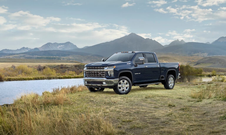 2023 Chevy Silverado 2500 HD parked by a lake and mountain views
