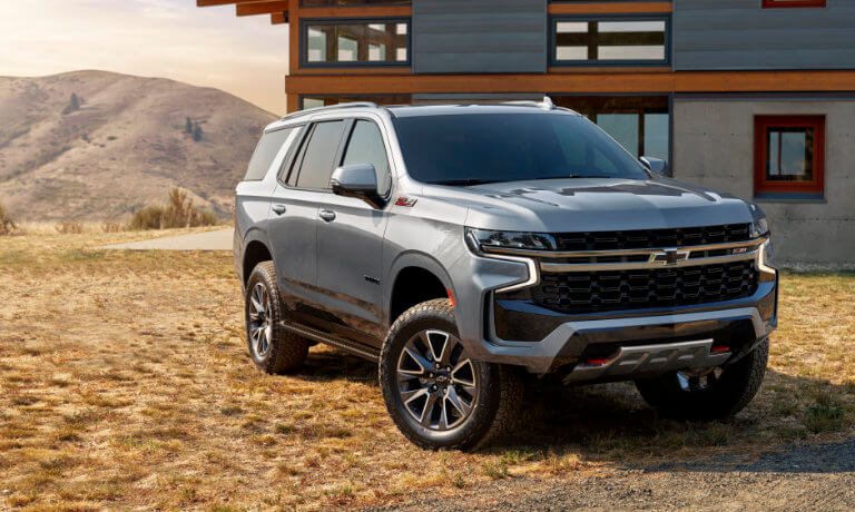2023 Chevy Tahoe parked in front of a modern barn home
