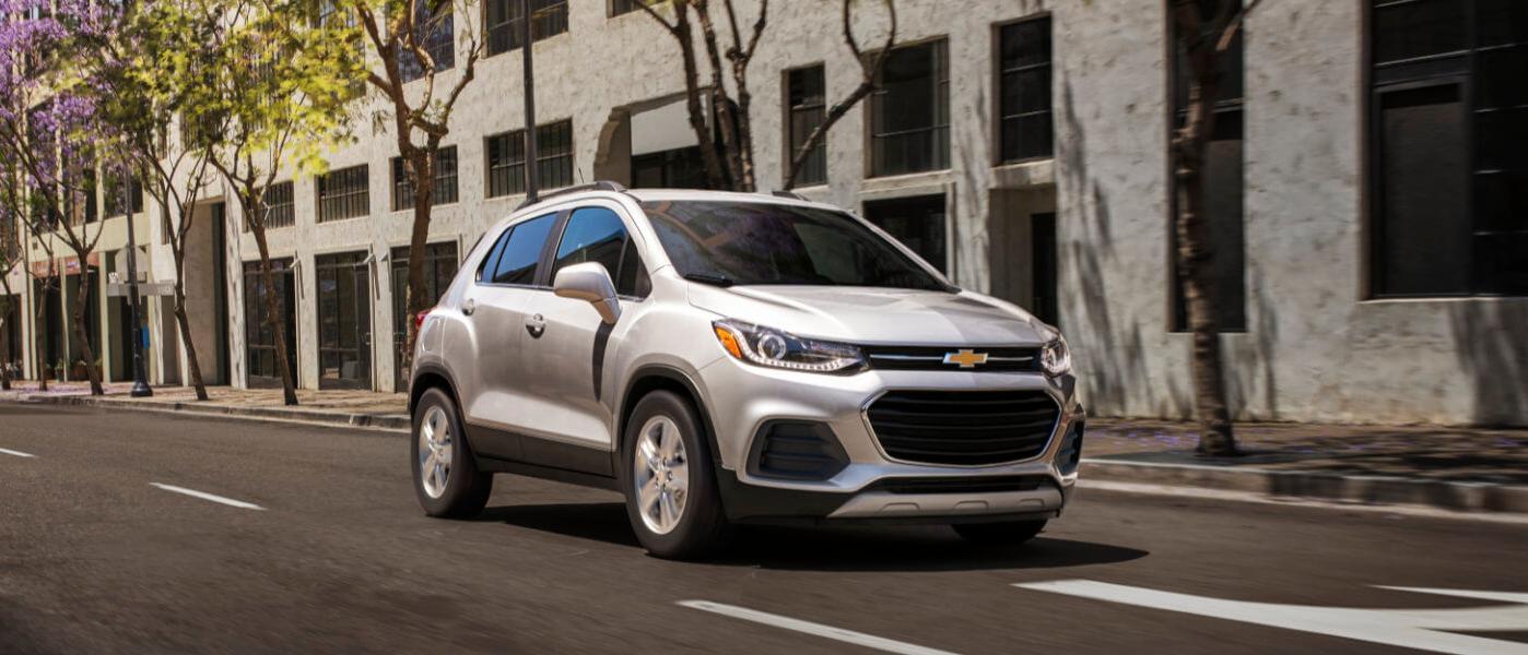 2021 Chevy Trax in white exterior driving on city road