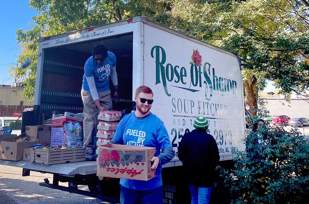 Landers McLarty Subaru Staff Unloading Truck for Rose of Sharon Soup Kitchen