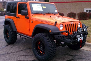 orange two door jeep wrangler