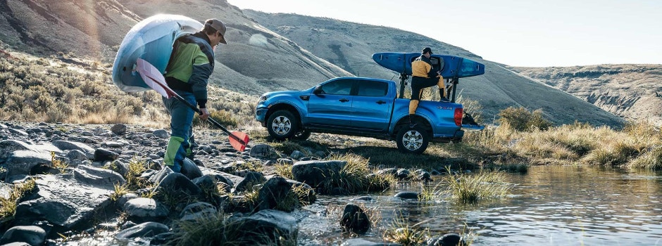 Two guys bringing their kayaks to their 2019 Ford Ranger
