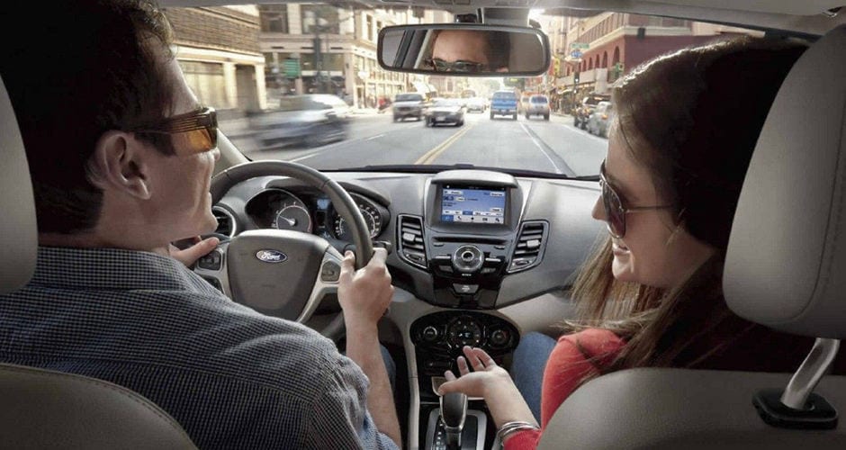 Two people laughing inside a Ford Fiesta