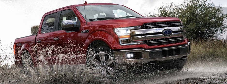 A 2018 Ford F-150 driving through the mud
