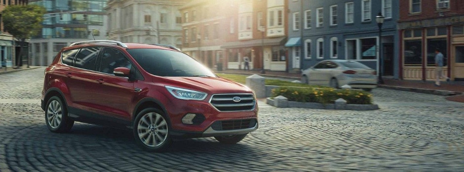 A 2018 Ford Escape driving on a brick road