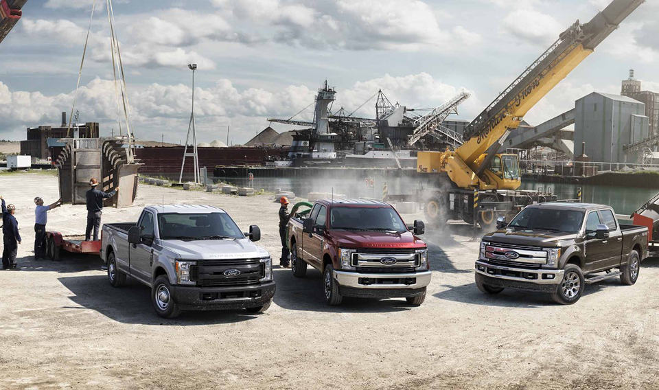 Three Ford commercial trucks parked next to each other