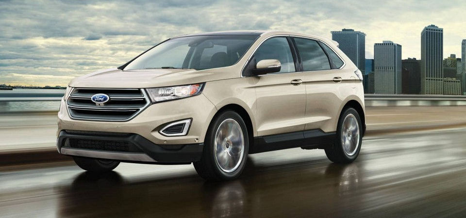 2017 Ford Edge driving fast along a wet road