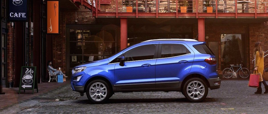 A blue 2018 Ford EcoSport parked outside of a cafe