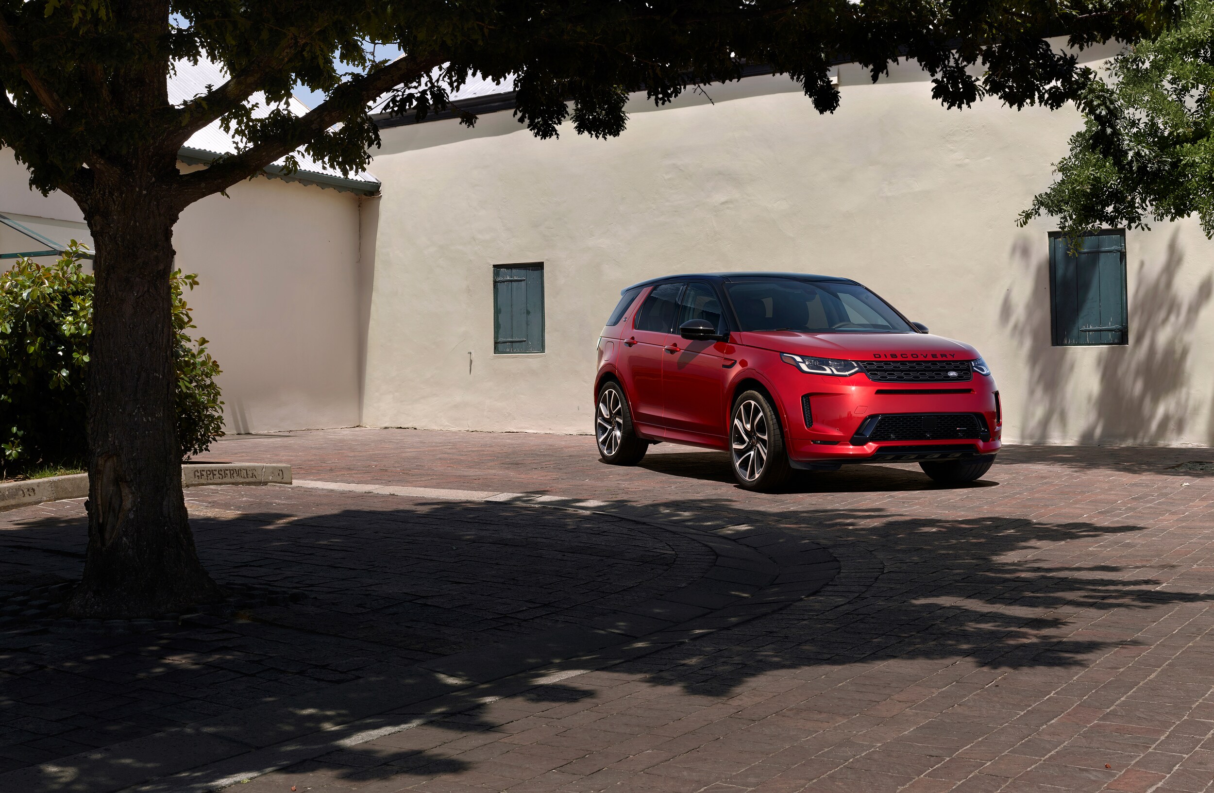 Red Range Rover Sport in driveway