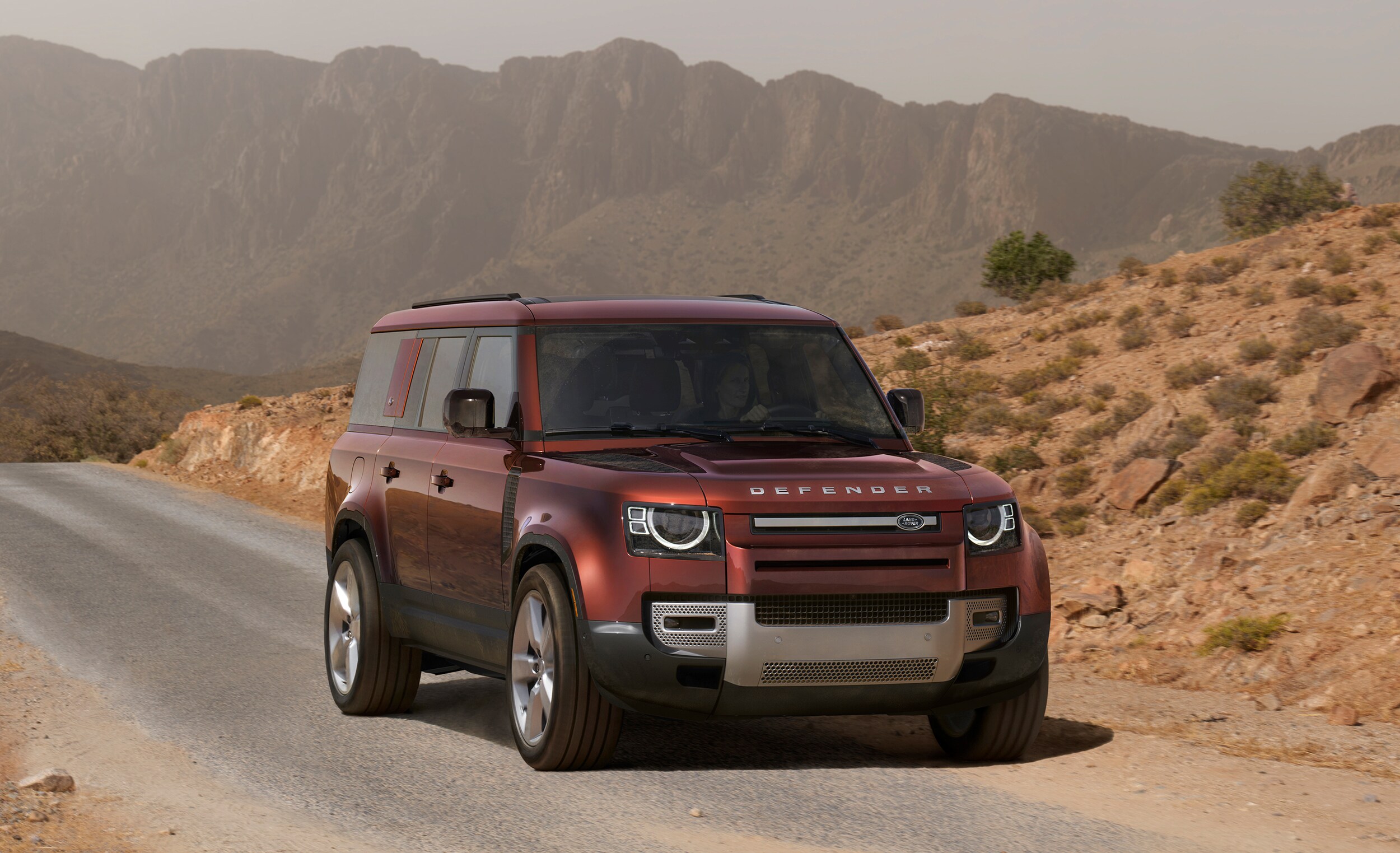Maroon Defender 130 driving