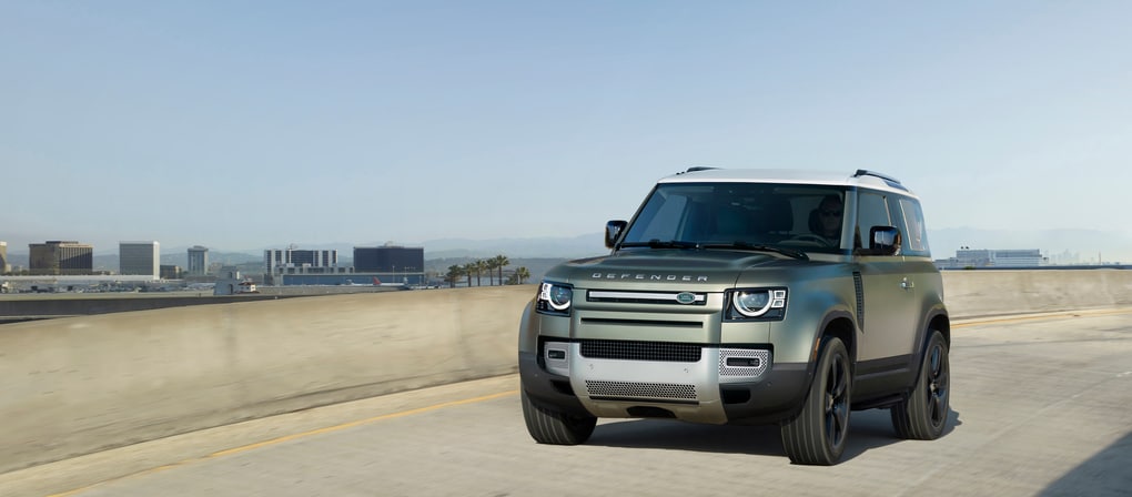 Green Defender 90 on the highway