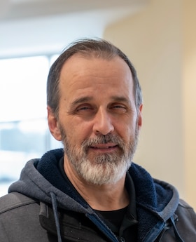 Staff member Christopher Benjamin from 8b704659a97c