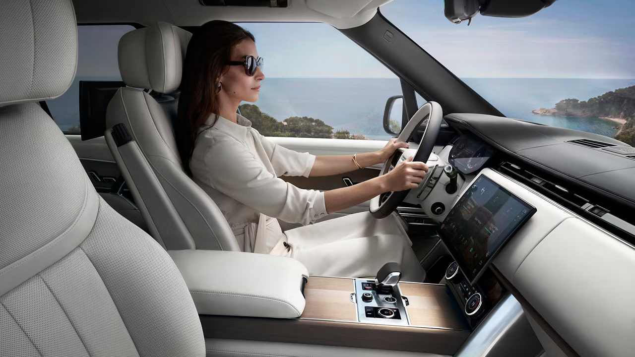 Woman driving in the 2026 Range Rover interior cockpit