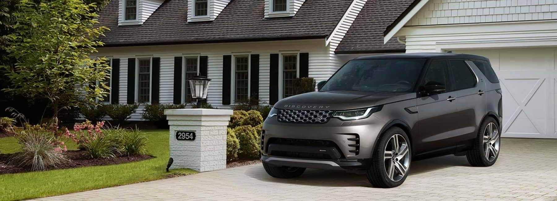 2022 Land Rover Discovery parked in the driveway of a large white house
