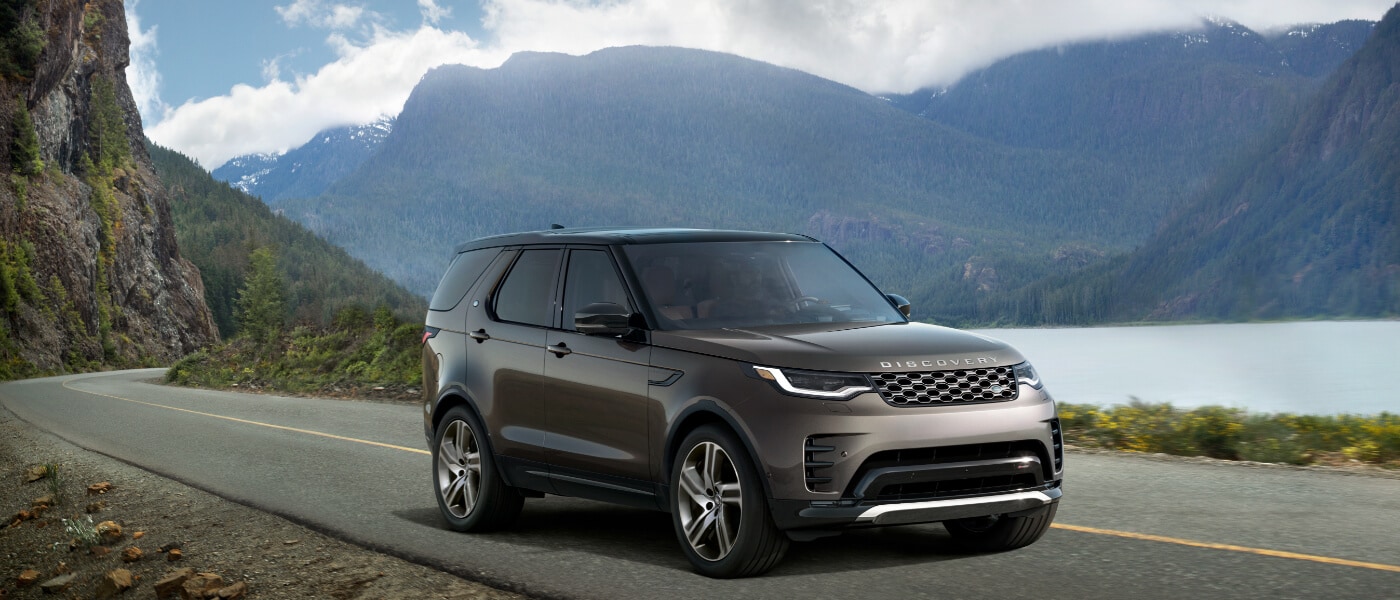 2025 Land Rover Discovery driving by water