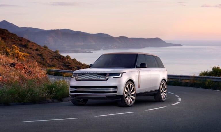 2026 Range Rover driving on a highway curve