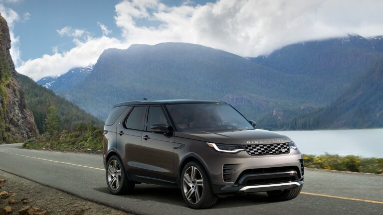 2025 Land Rover Discovery driving by the water