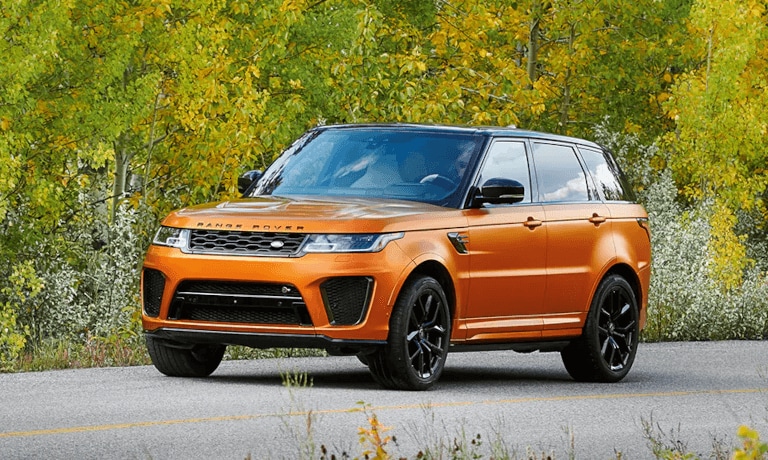 2021 Land Rover driving on tree-lined road