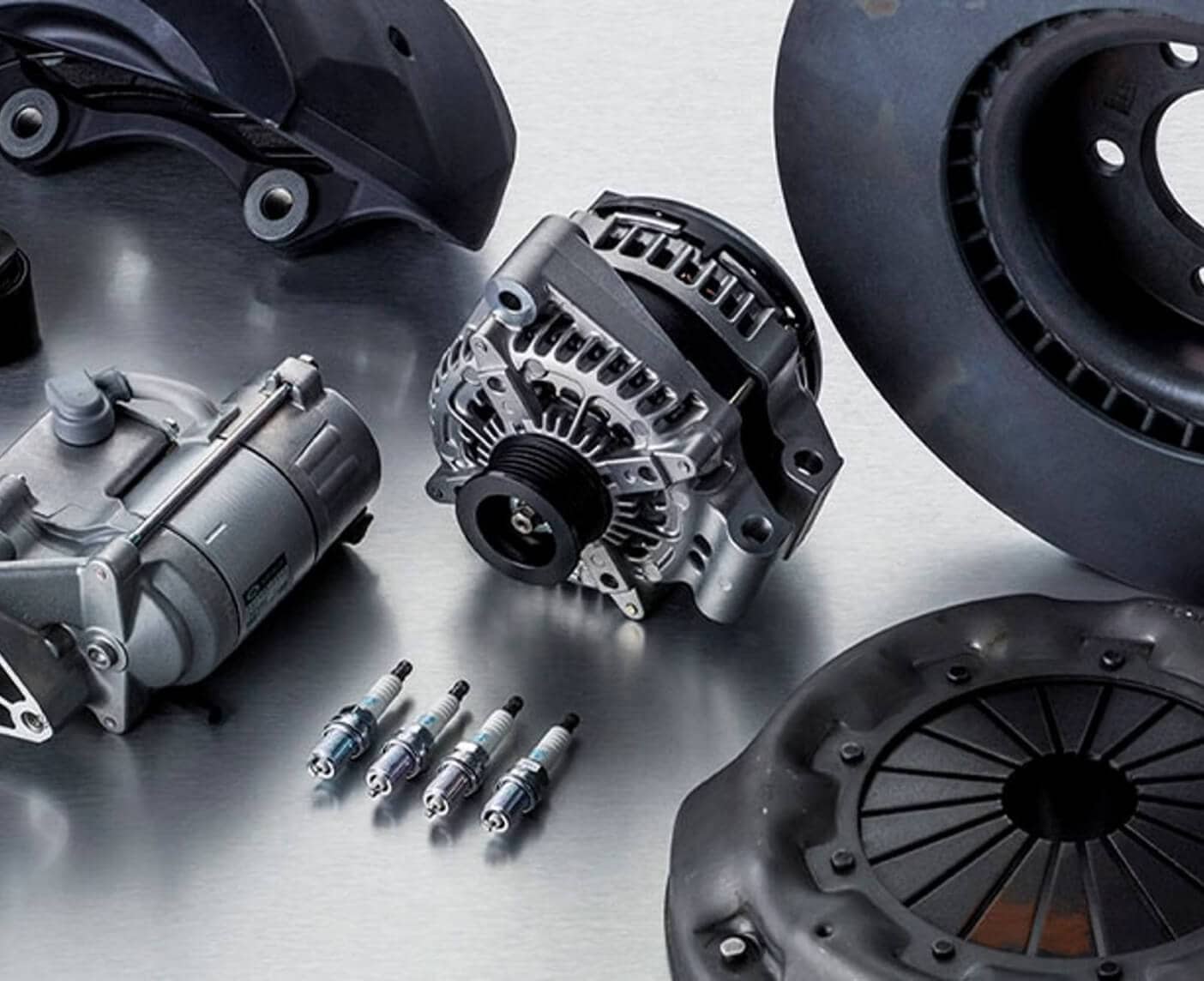Top-down view of Land Rover OEM parts arranged on a metal table.