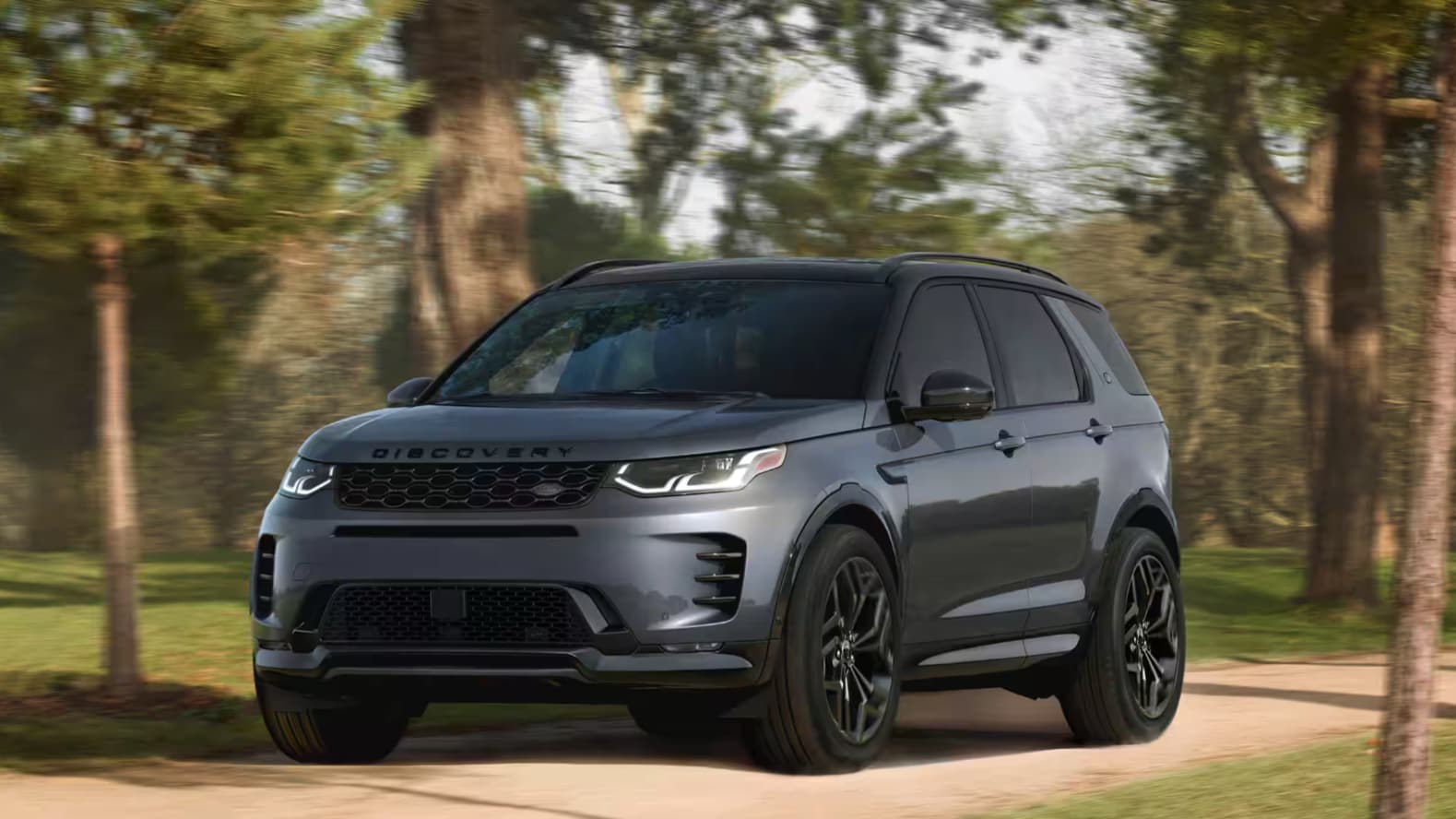 Discovery Sport driving through Glen Cove with a lease special or finance offer from Land Rover Glen Cove