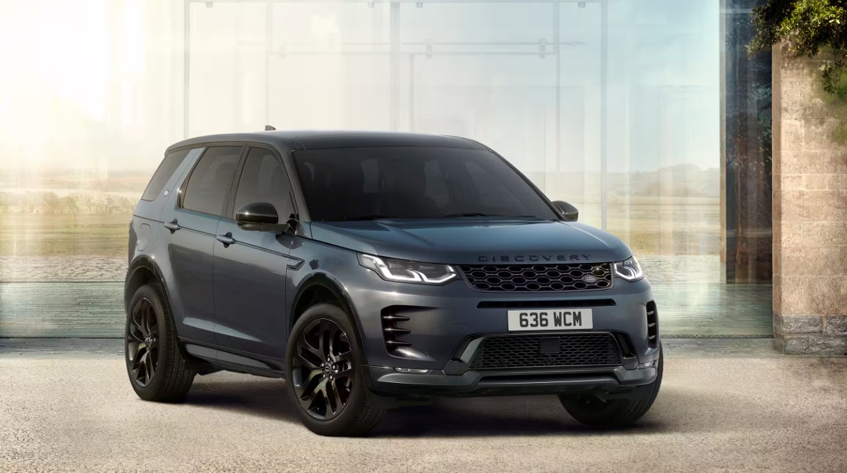 Front and side view of the 2024 Discovery Sport in front of a glass background