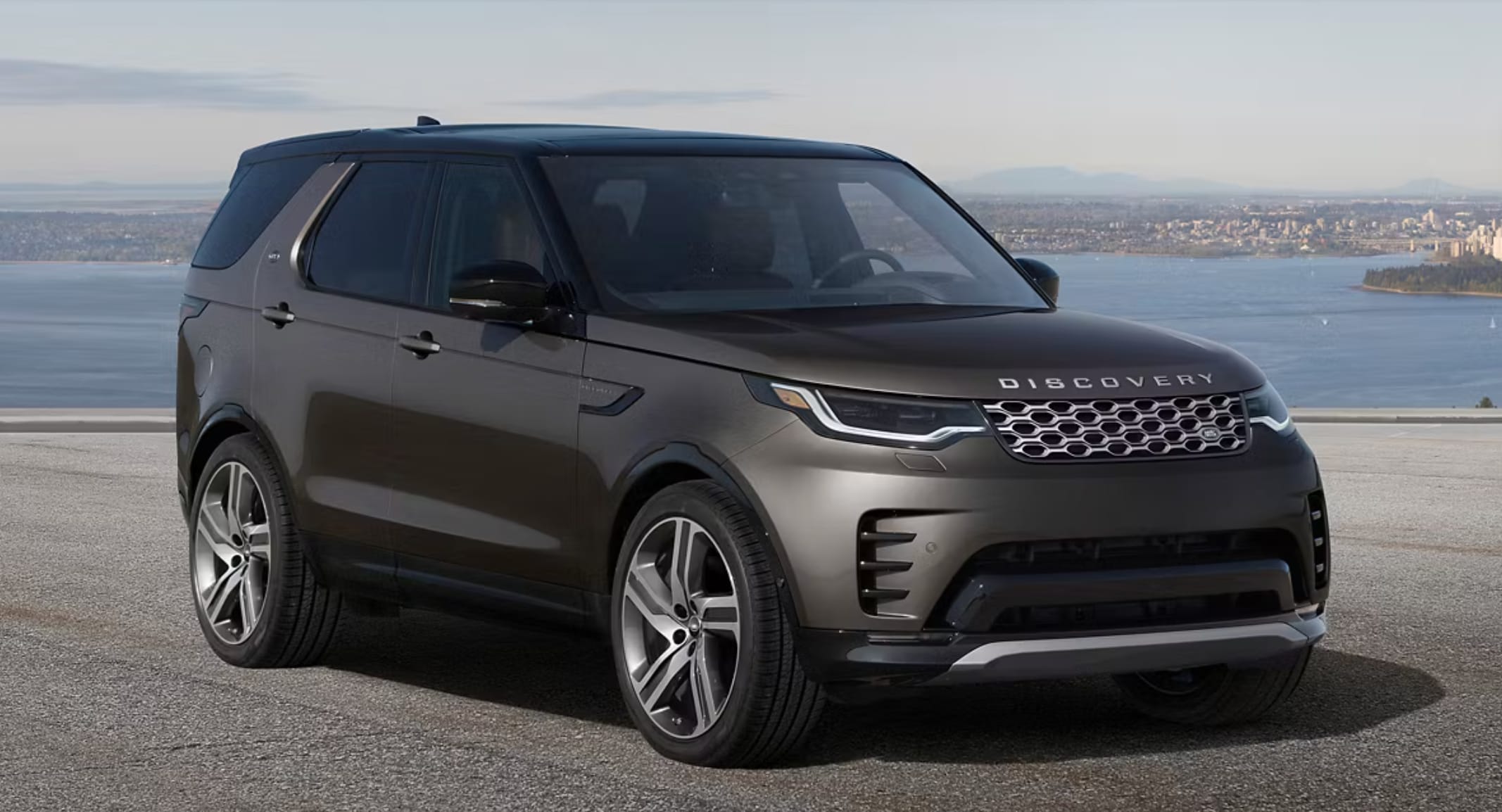 2025 Discovery parked in front of a bay