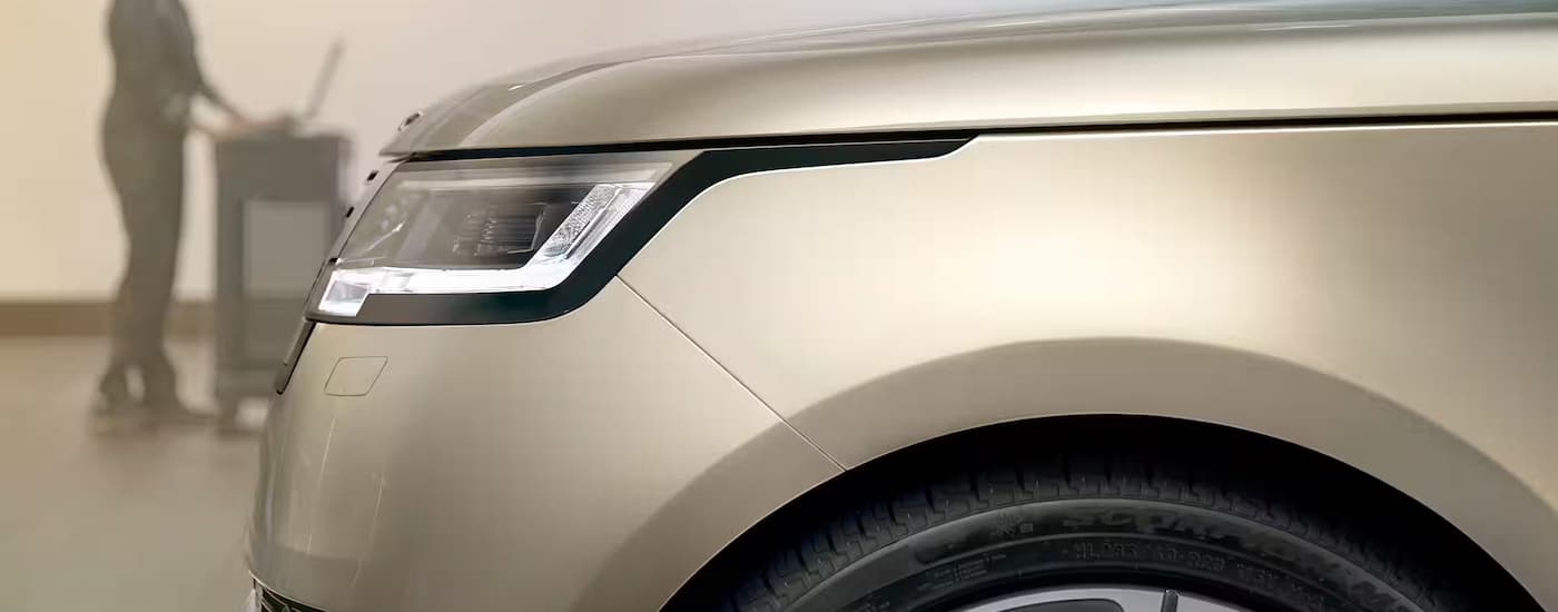 Tan 2026 Land Rover Range Rover Sport at a repair shop