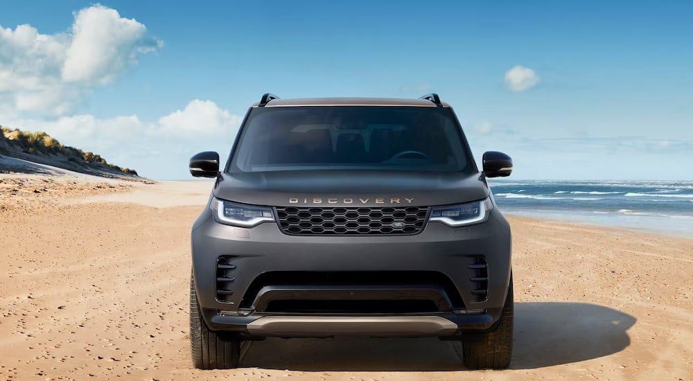 Front of a grey 2026 Land Rover Discovery parked off-road.