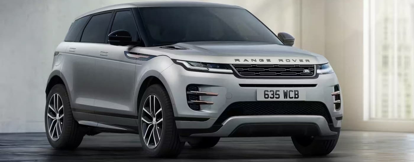 Silver 2023 Land Rover Evoque parked inside at an angle