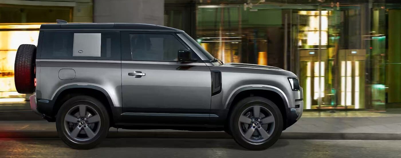 Silver 2023 Land Rover Defender 90 S parked on a city street