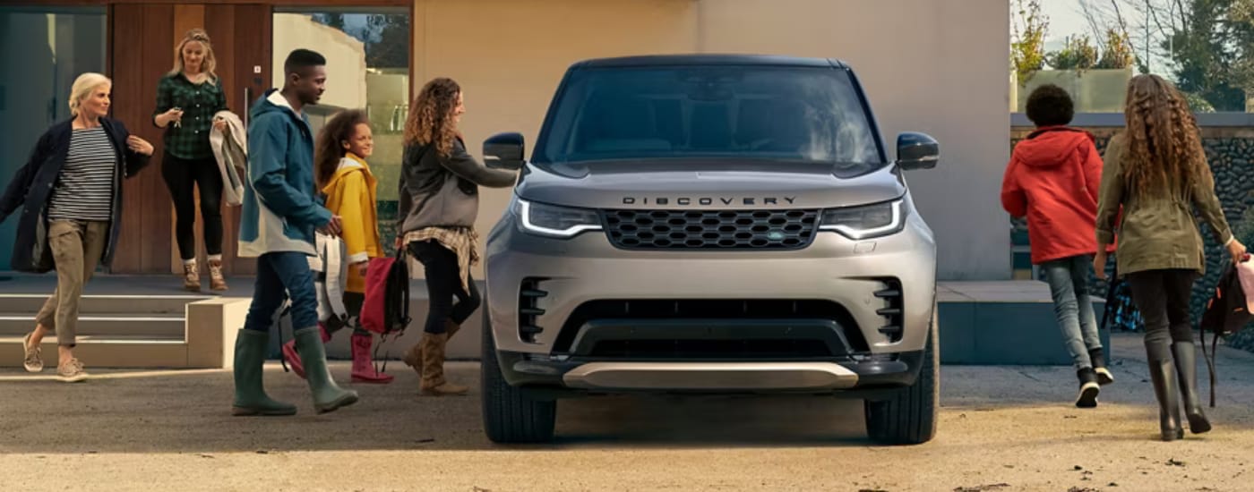 Tan 2026 Land Rover Discovery parked outside of a building