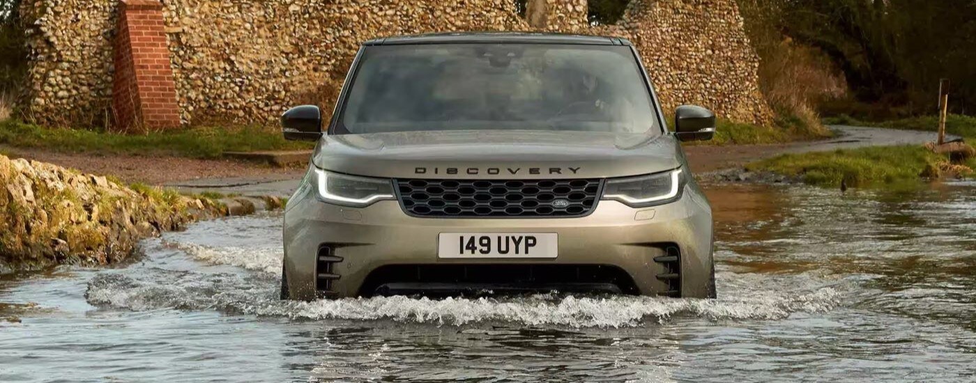 Green 2023 Land Rover Discovery doing a water crossing