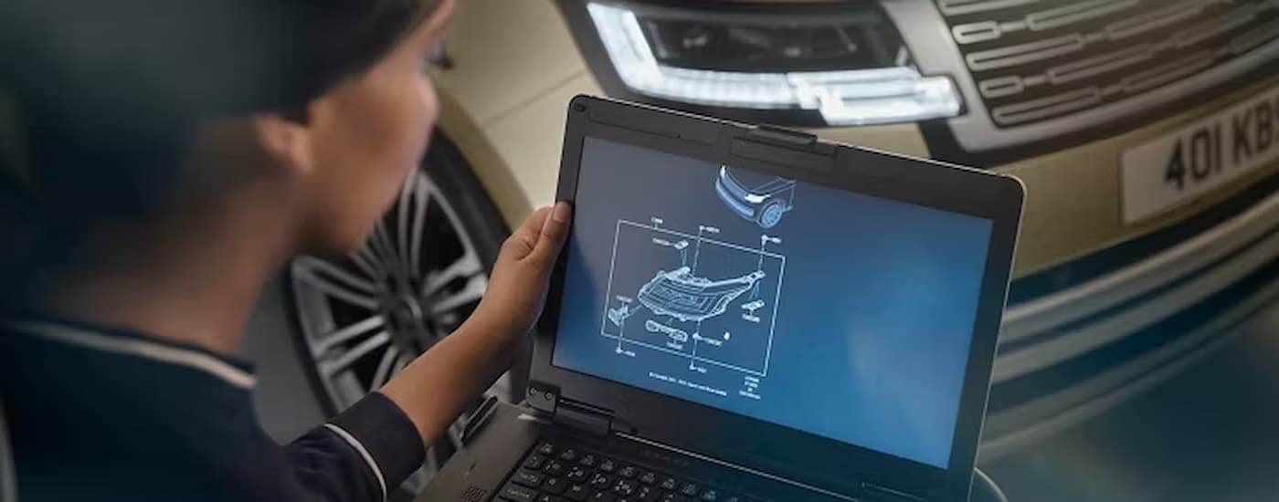 Woman using a computer to schedule Land Rover service